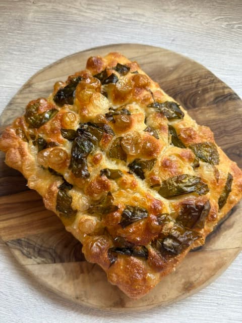 Golden focaccia on a wooden board